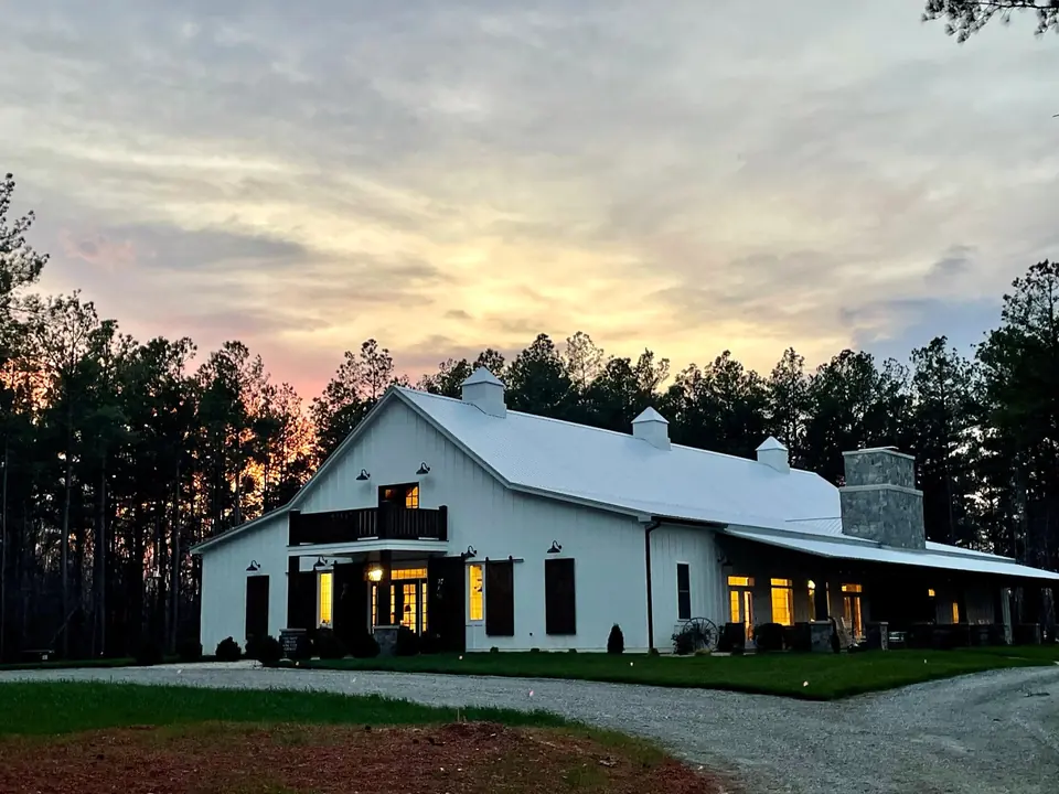 The barn’s lights coming on at dusk