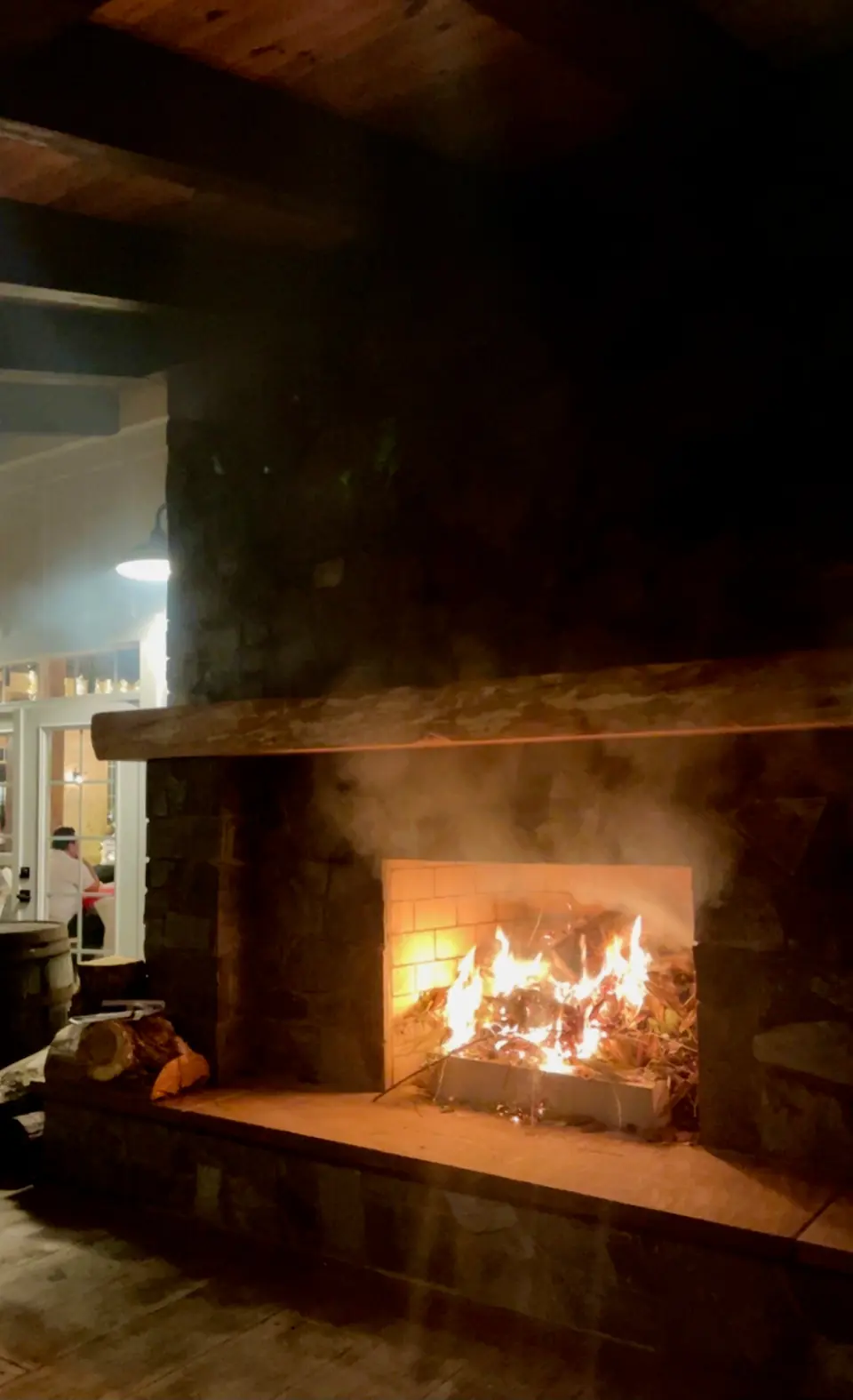 The indoor fireplace, lit