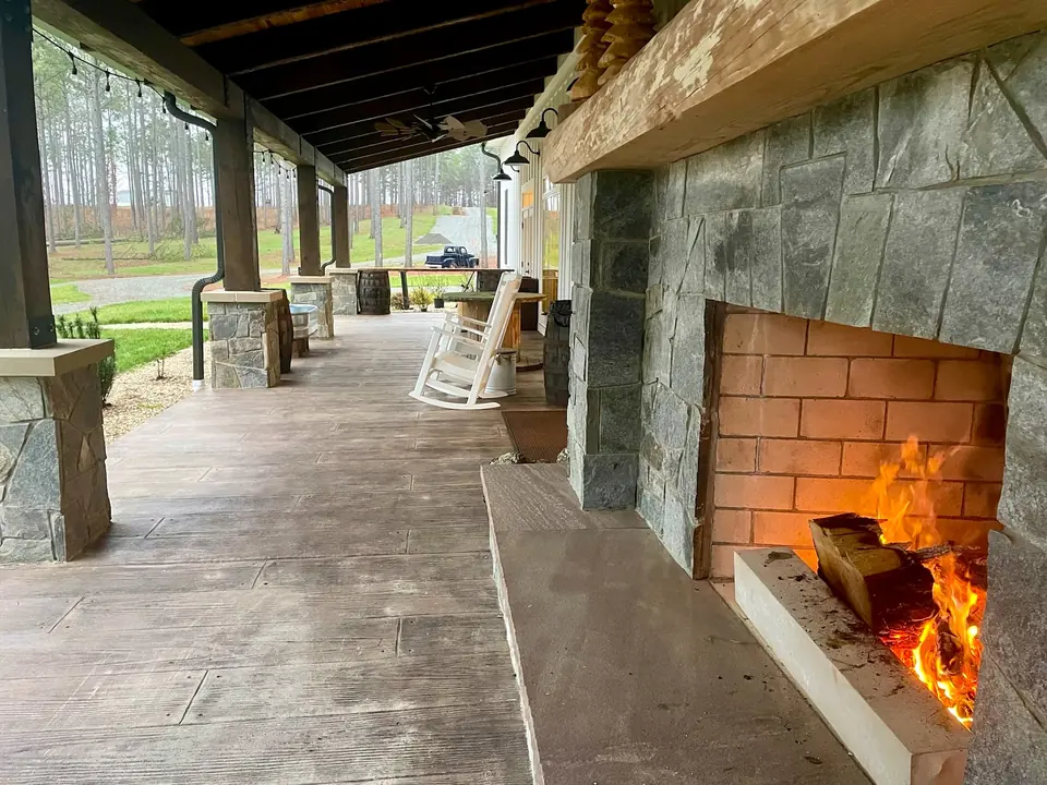 A fire burning in the stone fireplace on the porch
